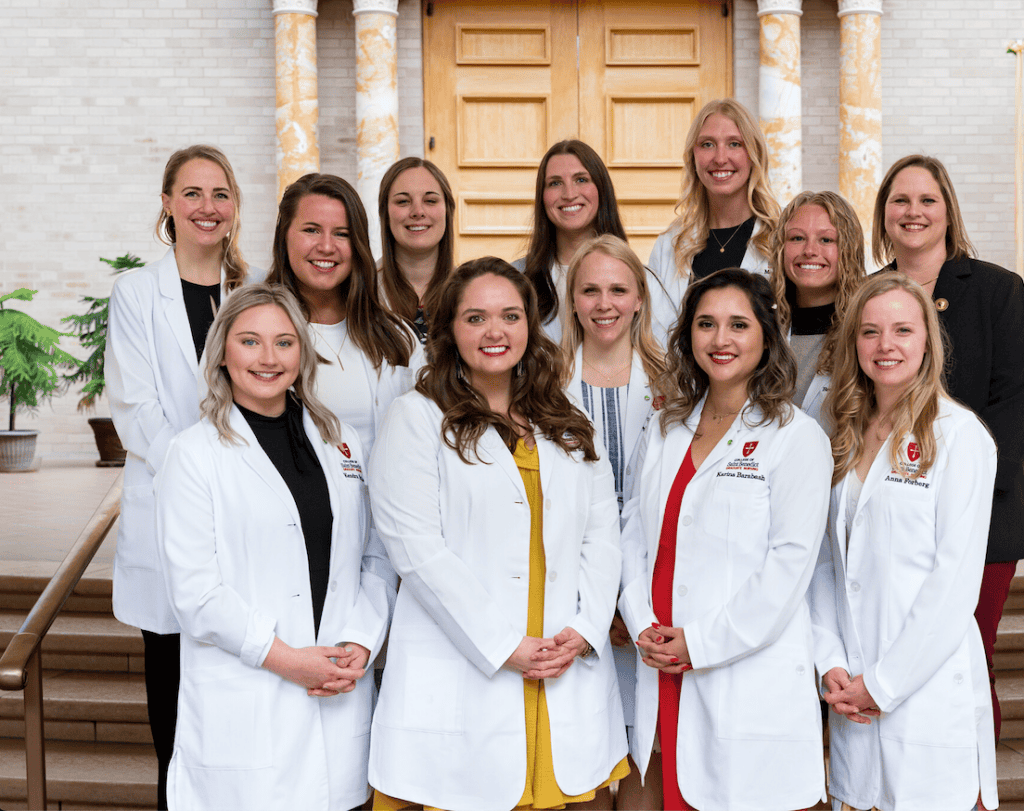 C S B Nursing graduate students posing after their white coat ceremony. 